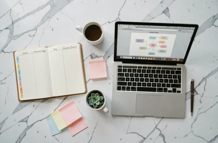 Vue aérienne d'un espace de travail de blogueuse avec planificateur, ordinateur portable et plan de site web
